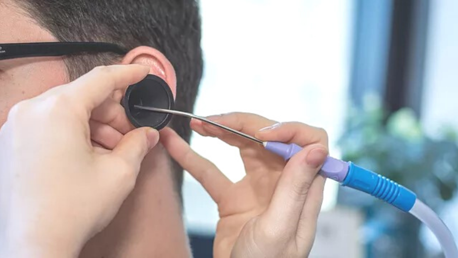 Doctor performing ear microsuction